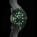 AERA D-1 Forest green dial glowing with Swiss Super-LumiNova in low light