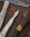 Yard-O-Led’s Grand Victorian Fountain Pen in one of its longest running and most popular writing instruments. The pattern is chased by hand, without using a stencil, by Yard-O-Led’s master silversmiths. The in-house team of artisans are able to recognise each other’s chasing work, in the same way a person’s handwriting would be familiar to those close to them. Each pen comes with a lifetime guarantee, and when a pen returns to the Yard-O-Led workshop for servicing the team is able to identify whose chasing